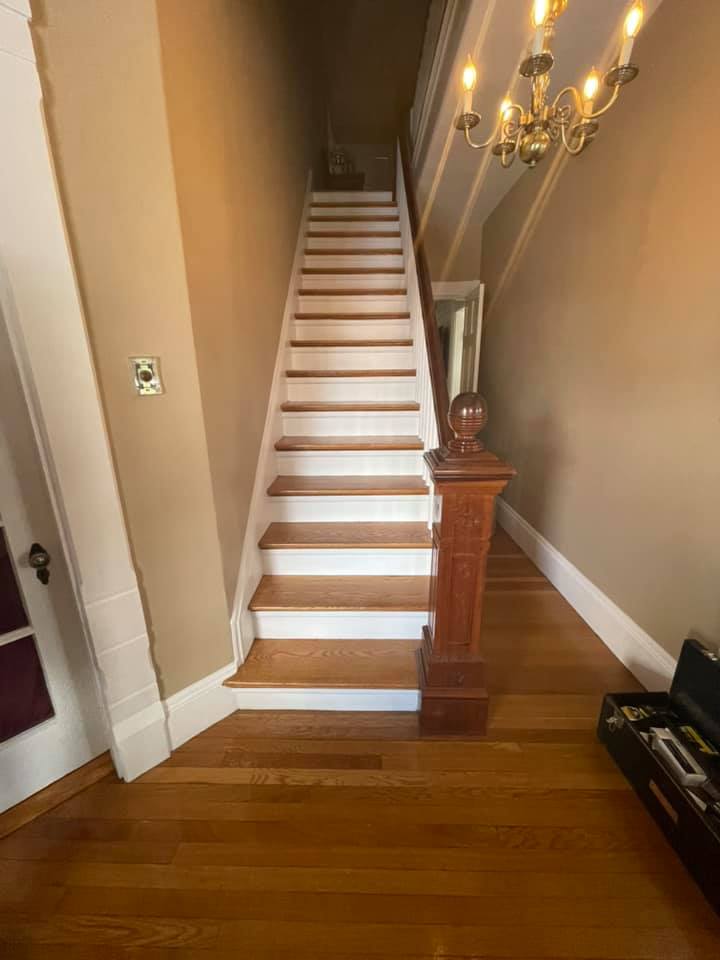 White and natural wooden stairwell before ornamental runner installation